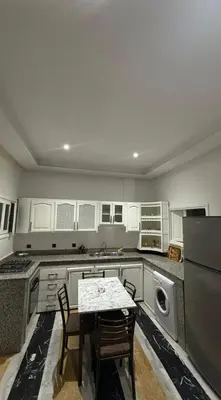 a kitchen with a table and chairs in it at Appartement au centre de Marrakech in Marrakech