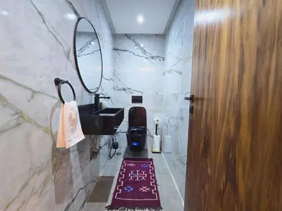 a bathroom with a sink and a mirror at Central New 1BR Next to the Train Station in Marrakech