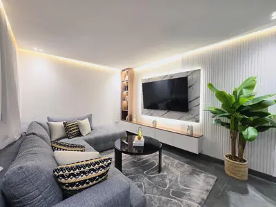 a living room with a couch and a tv at Central New 1BR Next to the Train Station in Marrakech