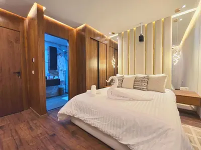 a bedroom with a large white bed and a desk at Central New 1BR Next to the Train Station in Marrakech