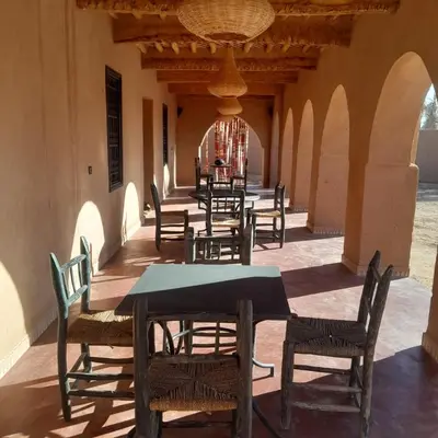 a row of tables and chairs in a building at Chants des dunes in Marrakech