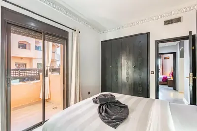 a bedroom with a bed and a large window at Nid Andalou balcony and calm in Oulad Akkou
