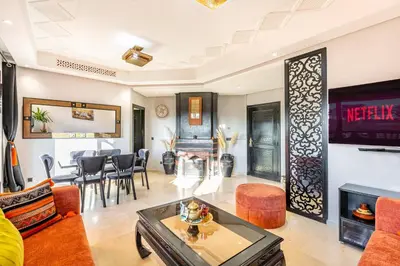 a living room with a couch and a table at Nid Andalou balcony and calm in Oulad Akkou