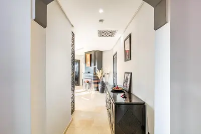 a hallway of a house with white walls and a black counter at Nid Andalou balcony and calm in Oulad Akkou