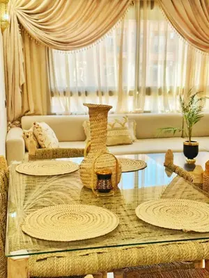 a living room with a table and a couch at Appartement Marrakech-GOLDEN OASIS in Marrakech