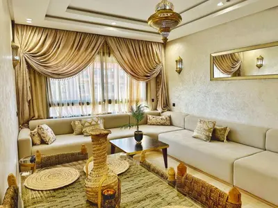 a living room with a couch and a table at Appartement Marrakech-GOLDEN OASIS in Marrakech