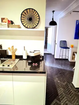 a kitchen with white cabinets and a black counter top at Central Atlas View in Marrakech
