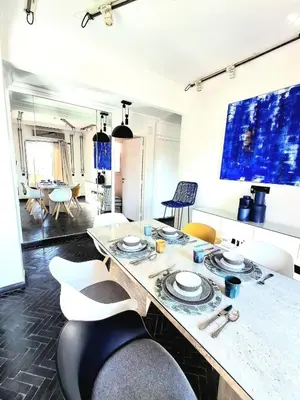 a living room with a table and some chairs at Central Atlas View in Marrakech