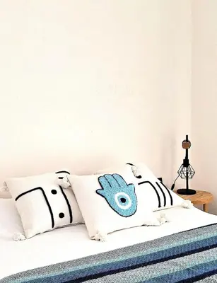 a bed with black and white pillows on it at Central Atlas View in Marrakech