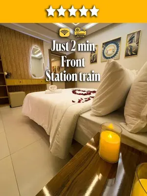 a hotel room with a bed and a table with a candle at Appartement Chic 2 Chambres Centre Marrakech près de la Gare in Marrakech