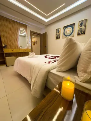 a hotel room with a bed and a candle on a table at Appartement Chic 2 Chambres Centre Marrakech près de la Gare in Marrakech