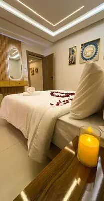a bedroom with a bed with a candle on a table at Appartement Chic 2 Chambres Centre Marrakech près de la Gare in Marrakech