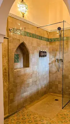 a bathroom with a shower with a glass door at Private - Riad Désiré Marrakech in Marrakech