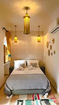 a bedroom with a bed with two towels on it at Private - Riad Désiré Marrakech in Marrakech