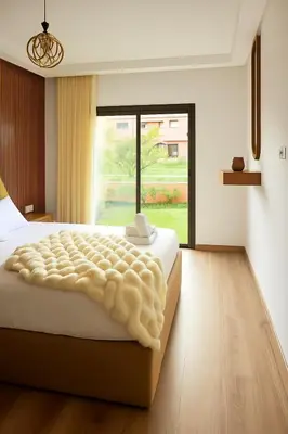 a bedroom with a large bed with a large window at Sophisticated & Cozy Home in Vibrant Marrakech in Marrakech