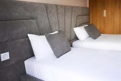 two beds with pillows in a hotel room at Sophisticated & Cozy Home in Vibrant Marrakech in Marrakech