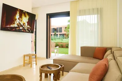 a living room with a couch and a fireplace at Sophisticated & Cozy Home in Vibrant Marrakech in Marrakech