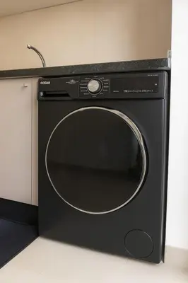 a black microwave oven sitting in a kitchen at 2 chambres avec terrasse vue piscine in Marrakech