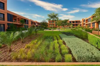 a garden in front of an apartment building at Atlas Luxury Escape Golf Noria Pool & Quiet in Marrakech