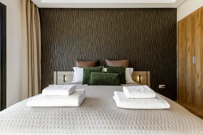 a bedroom with a large bed with two white pillows at Atlas Luxury Escape Golf Noria Pool & Quiet in Marrakech