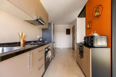 a kitchen with a sink and a microwave at Atlas Luxury Escape Golf Noria Pool & Quiet in Marrakech