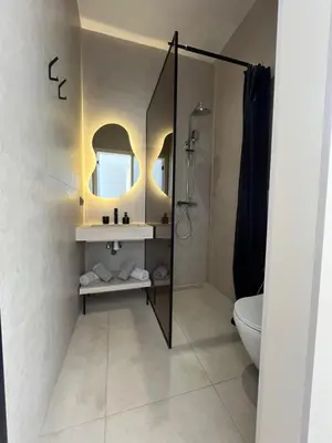 a bathroom with a sink and a toilet and a mirror at Villa Marraktus Marrakech in Marrakech