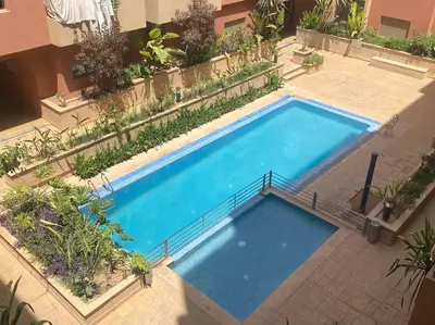 an overhead view of a large blue swimming pool at Appartement de luxe avec piscine in Marrakech