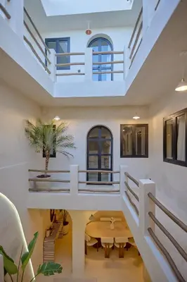 a living room with a table and a balcony at Luxury Private Riad - Pool - Breakfast Included in Marrakech