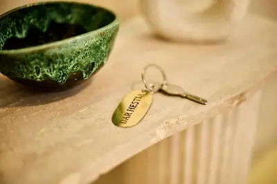 a keychain on a table next to a green bowl at Luxury Private Riad - Pool - Breakfast Included in Marrakech