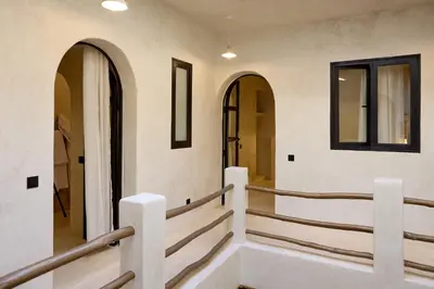 a staircase in a building with arched windows at Luxury Private Riad - Pool - Breakfast Included in Marrakech