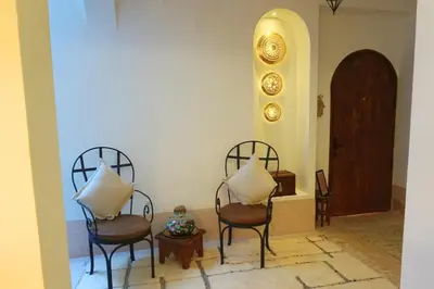 two chairs with pillows sitting in a room at Little date in Marrakech