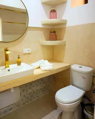 a bathroom with a toilet and a sink and a mirror at Little date in Marrakech