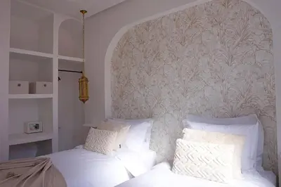 a bedroom with two beds with white pillows at Little date in Marrakech