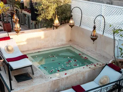 a swimming pool with a bunch of people in it at Riad Jebly - Exclusive -Jacuzzi & Breakfast ,10 min walk Jemaa El Fnaa - Panoramic View Rooftop in Marrakech