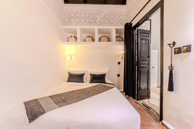 a bedroom with a white bed in a room at Riad Jebly - Exclusive -Jacuzzi & Breakfast ,10 min walk Jemaa El Fnaa - Panoramic View Rooftop in Marrakech