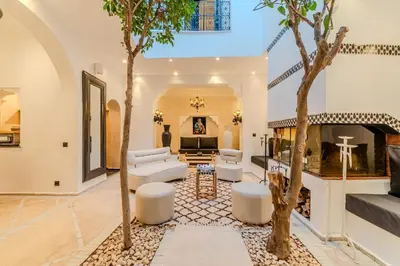 a living room with white furniture and a fireplace at Riad Jebly - Exclusive -Jacuzzi & Breakfast ,10 min walk Jemaa El Fnaa - Panoramic View Rooftop in Marrakech