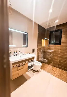 a bathroom with a sink and a toilet and a shower at Stylish 2-bed flat in Marrakech city center - steps from train station in Marrakech