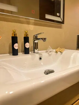 a bathroom sink with two soap bottles on it at Stylish 2-bed flat in Marrakech city center - steps from train station in Marrakech