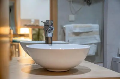 a white bowl sink with a faucet on a counter at CAN 2025 - T2 design Gare de Marrakech - Guéliz-Hivernage - WiFi in Marrakech