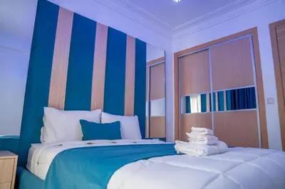 a bedroom with a blue and white bed with towels on it at CAN 2025 - T2 design Gare de Marrakech - Guéliz-Hivernage - WiFi in Marrakech