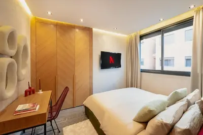 a bedroom with a bed and a table and a desk at Cocooning escape Relaxation, design and serenity in Marrakech