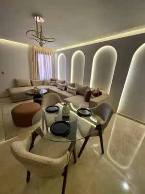 a living room with a glass table and chairs at Urban Studio Guéliz in Marrakech