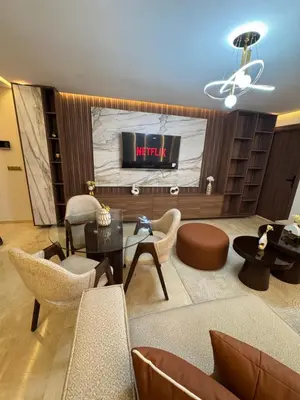 a living room with a couch and chairs and a tv at Urban Studio Guéliz in Marrakech