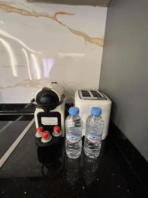 two bottles of water sitting next to a blender at Urban Studio Guéliz in Marrakech