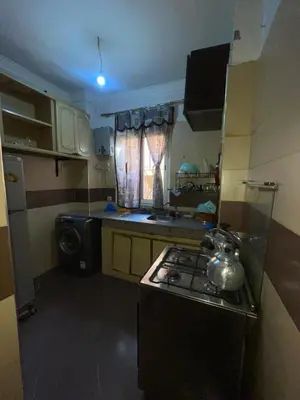 a small kitchen with a stove and a sink at Abwab guiliz in Marrakech