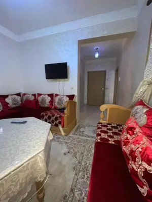 a living room with a couch and a tv at Abwab guiliz in Marrakech