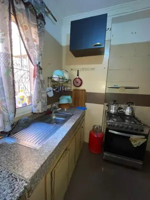 a kitchen with a sink and a stove at Abwab guiliz in Marrakech