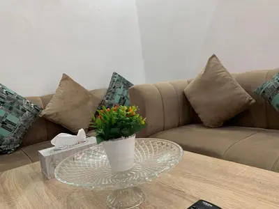 a coffee table with a vase with flowers on it at Appart Jamaa lafna square in Marrakech