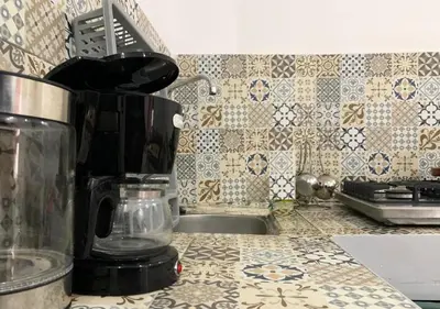 a kitchen counter with a coffee maker on a counter top at Appart Jamaa lafna square in Marrakech