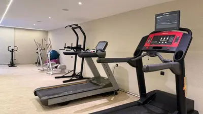 a room with a gym with a treadmill and a phone at Mosaic 54 - Terrasse & Piscine chauffée - M Avenue in Marrakech
